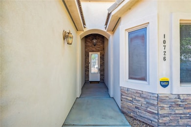Entrance to property with stucco siding and stone