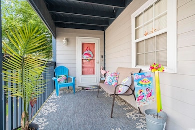 View of exterior entry featuring covered porch