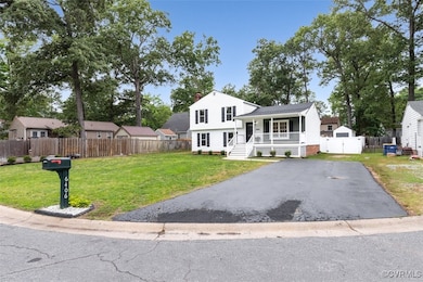 Split level home with covered driveway, a chimney,