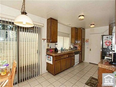 Large kitchen with granite counters and doors out 