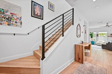 Stairway featuring hardwood / wood-style flooring