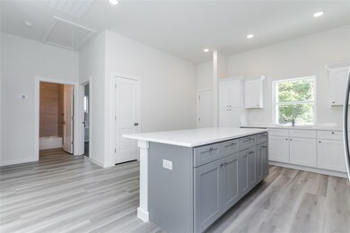 Kitchen with light hardwood / wood-style floors, w