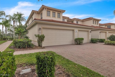 Mediterranean / spanish-style home with decorative driveway, stucco siding, and a tiled roof