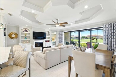 Living area featuring ornamental molding, a glass 