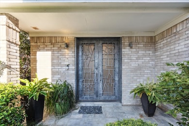 Enter through the custom  designed steel double doors into the spacious foyer.