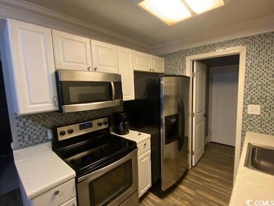 Kitchen with decorative backsplash, appliances wit