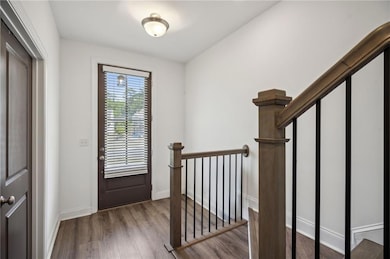 Entryway with wood finished floors and baseboards