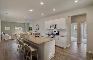 Kitchen with light stone counters, stainless steel