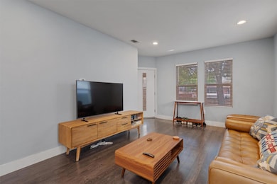 Living room with baseboards, recessed lighting, a