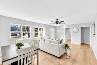 Living room featuring a ceiling fan, baseboards, a