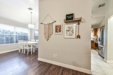 While the kitchen is not completely open to the living room, this photo shows how all the spaces unite. The living room is open to the dining room which opens to the kitchen. This wall gives just a bit of separation between the two spaces but does not completely cut things off.