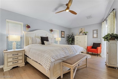 Bedroom featuring ceiling fan, hardwood / wood-sty