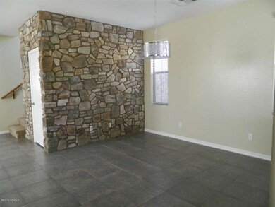Formal dining room w/ stone accent wall