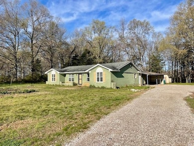 View of front of home with an attached carport, a 