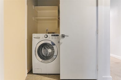Convenient laundry nook featuring extra storage for efficiency.