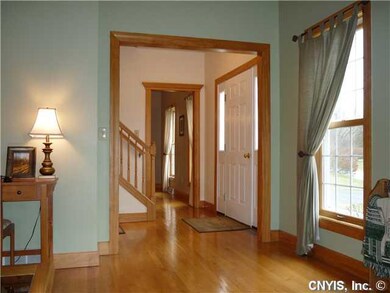 Foyer. Glistening hardwood floors and natural wood