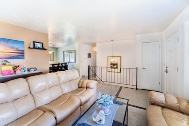 Living area with a chandelier and tile patterned flooring