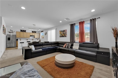 Living area with light carpet, recessed lighting,