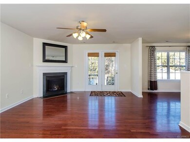 The living room has hardwood flooring, gas firepla