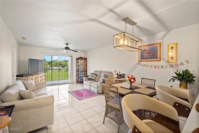 Tiled living room with ceiling fan with notable ch
