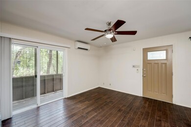 Spare room featuring a wall unit AC, ceiling fan,