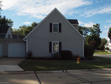 Side entry of condo with new garage door and fresh