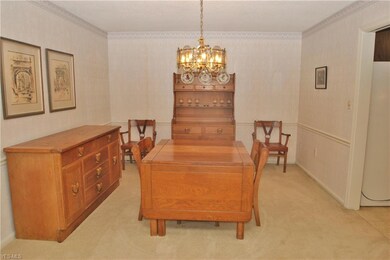 Formal dining room has chair rail & chandelier and