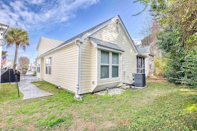 View of home's exterior with central AC, a yard, a