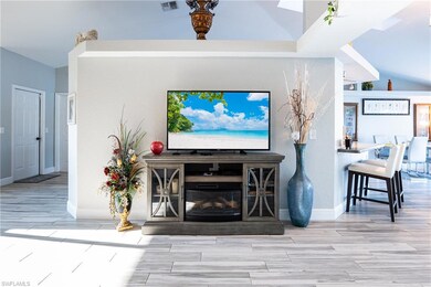 Living room featuring lofted ceiling and light har