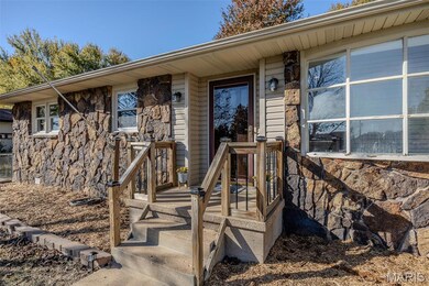 Entrance to property with stone siding