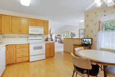 Kitchen leads into formal dining and living room areas,