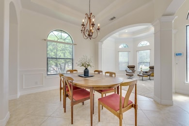 Dining area with a raised ceiling, ornate columns