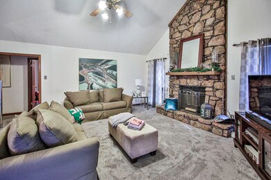 Living room with ceiling fan, high vaulted ceiling