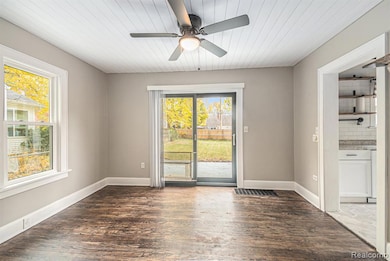 Unfurnished room with wood finished floors, a ceiling fan, and wooden ceiling
