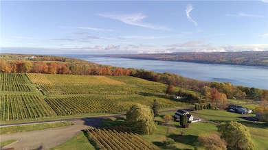 As you drive in, the view opens wide over rolling vineyards that sweep down toward the deep blue waters of Seneca Lake.