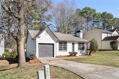 View of front of home featuring a front yard, a ch