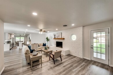 Living room with brick wall, a brick fireplace, a 