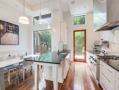 Kitchen featuring stainless steel range, island r