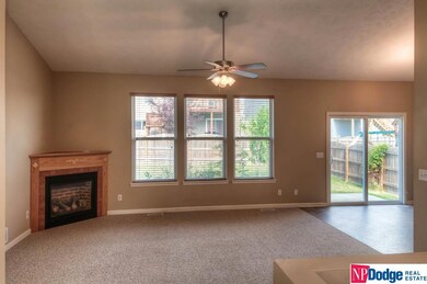Cathedral Ceiling with gas fireplace focal point. Open to kitchen.