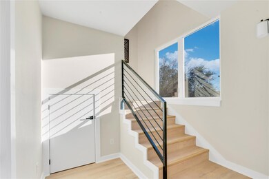 Stairs featuring wood finished floors and baseboa