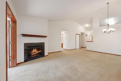 Large living and formal dining area with gas fireplace.