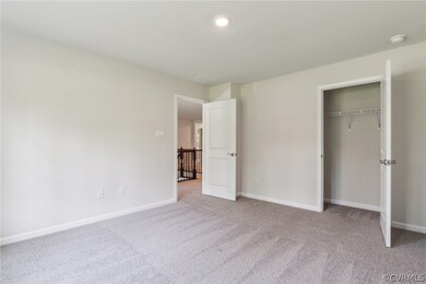 Unfurnished bedroom with carpet and a closet