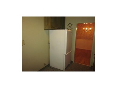 Kitchen. Small eating area next to refrigerator