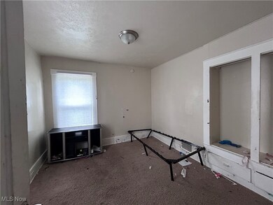 Unfurnished bedroom featuring a textured ceiling and carpet floors