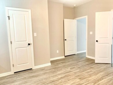 Unfurnished bedroom featuring light wood-type flooring and baseboards