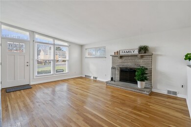 This living room has large front windows that let