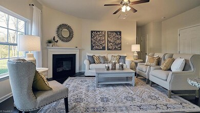 Living Room. This picture is of the Charleston plan as a decorated plan and not the actual home. It is being used to demonstrate the plan only. The actual home is under construction. Options & color selections may vary from picture to the actual home. Decorative paint, decor & furnishings are not included in actual home.