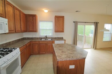 The kitchen includes a center island, pantry, & al