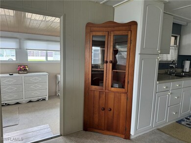 Dining area with sink and light colored carpet