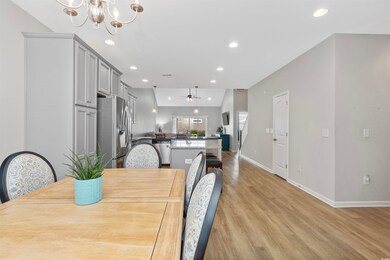 Dining area with light wood-type flooring, recessed lighting, a chandelier, baseboards, and a ceiling fan